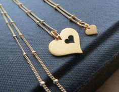 An adorable gift for mother'sday. This gold necklace set includes both the large pendant with heart cut out, as well as the teeny tiny heart charm that fits right in place.the charms are gold plated over sterling silver base metal and the chains are 14k gold filled. tiny heart -4.5mm widelarger heart-14.4mm wideYou can find more options for Mother daughter jewelry~https://www.etsy.com/shop/thejewelrybar?section_id=16156806&ref=shopsection_leftnav_2 Mother Daughter Jewelry, Mother Of The Bride Gift, Mother Daughter Necklace, Cheap Necklaces, Wedding Day Jewelry, Heart Cut Out, Mother Daughter Gifts, Daughter Jewelry, Daughter Necklace