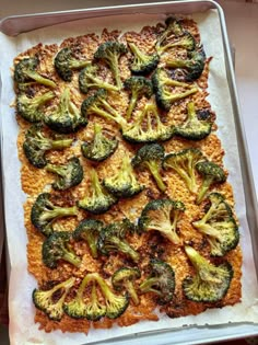 broccoli florets are on top of rice in a pan, ready to go into the oven