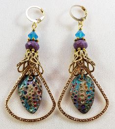 Hand-Painted Earrings. The centerpiece of these earrings are the beautiful hand-painted on copper with resin charms made by Washington State artist Kristi. I accented them with rounded triangle connectors, vintage brass bead caps, purple faceted Czech glass beads and turquoise Swarovski crystal bicone beads. These earrings are 3 inches long including the pure brass round lever back closures. One Of A Kind I can send it gift wrapped (free of charge), if requested. Artistic Hand Painted Copper Earrings, Bohemian Enamel Earrings Nickel-free, Bohemian Enamel Earrings Nickel Free, Bohemian Hand Painted Metal Jewelry, Nickel-free Bohemian Enamel Earrings, Handmade Bronze Brass Teardrop Earrings, Handmade Bronze Czech Glass Earrings, Hand Painted Copper Bohemian Earrings, Bohemian Hand Painted Copper Earrings