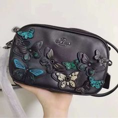 Coach Butterfly Applique Crossbody Clutch In Pebble Leather Calf Leather Inside Credit Card, Cell Phone And Multifunction Pockets Zip-Top Closure, Fabric Lining Long Strap With 22 1/2" Drop For Shoulder Or Crossbody Wear 7 1/2" (L) X 4 1/2" (H) X 1 1/2" (W) Coach Butterfly, Coach Parker, Tan Leather Handbags, Butterfly Applique, Patent Leather Bag, Black Leather Satchel, Bags Coach, Boho Purses, Star Bracelet