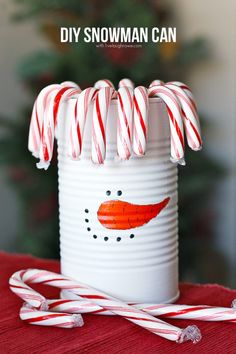 a white can with candy canes and a snowman painted on it