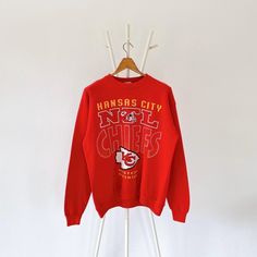 90s Kansas City Chiefs KC NFL sweatshirt/ M * PLEASE READ BEFORE PURCHASE * PLEASE consider the PHOTOS before making the decision * The images may DIFFER in appearance from the actual product because we took pictures under daylight.  * PLEASE send your PHONE NUMBER after your purchase for the shipping company to contact you X No returns X No refund Condition : 8/10 More details : stains (sleeves)/ look at the pictures  Brand : Artex Size : M Pit to pit/ Chests : 22/44 inches  Length : 26 inches  Material : cotton polyester  Color : red * ALL ITEMS are VINTAGE which may show some signs of wear and tear * Due to the different display and different light, the picture may not reflect the actual color of the item * Please, remember that our items are vintage so they may show some signs of wear, 90s Style Long Sleeve Sweatshirt Fan Merchandise, 90s Graphic Print Sweatshirt For Sports Season, 90s Style Graphic Print Sweatshirt For Fans, 90s Graphic Print Sweatshirt For Fans, 90s Style Crew Neck Sweatshirt With Screen Print, 90s Crew Neck Sweatshirt With Screen Print, 90s Style Winter Sweatshirt For Fans, Vintage Long Sleeve Sweatshirt For Fan Merchandise, Vintage Long Sleeve Fan Merchandise Sweatshirt