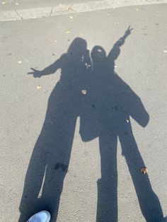 the shadow of two people standing next to each other