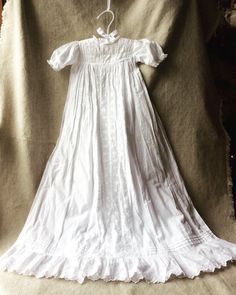 "For Your Consideration... Simple Elegant Victorian Christening Gown Classic Family Heirloom Hand Made Gossamer fine all cotton w/lace Measures 34 inches from shoulder to hem. Shoulder 11\" across Sleeves 5 inches long Waist measure 17.5inches. SizeAprox up to 6months. Due to the vintage nature of this item, it has no size tag so please use the measurements provided to determine the sizing. No signs of yellowing with age. I found a few amazing gowns while on a recent trip to la Belle France... A Cotton Victorian Dress With Fitted Bodice For Daywear, Victorian Cotton Dress With Historical Design, Vintage Cotton Victorian Wedding Dress, Fitted Victorian Dress With Broderie Anglaise For Wedding, Victorian Cotton Dress With Broderie Anglaise, Regency Style Fitted Gown With Lace Trim, Fitted Cotton Prairie Dress For Weddings, White Cotton Victorian Dress, Fitted Cotton Gown For Baptism