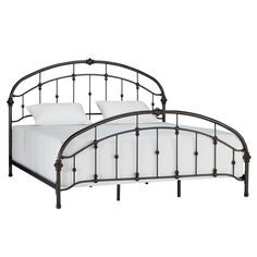 an iron bed frame with white sheets and pillows on the headboard, against a white background