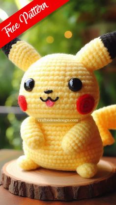 a crocheted pikachu sitting on top of a tree stump