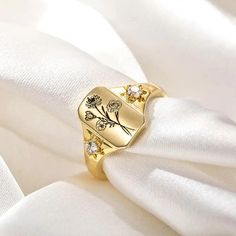 Elevate your style with our Combined Birth Flower Ring - a symbol of familial love and connection, beautifully encapsulated in a dainty and minimalist design. This exquisite signet ring celebrates the unique bond shared between family members, making it a perfect gift for yourself or a cherished loved one. 🔸 Personalized Engraving: Customize the ring with the birth flowers of your loved ones, with space for up to 6 flowers. Each flower represents a special individual in your family, creating a Elegant Adjustable Flower Ring For Mother's Day, Elegant Flower Ring For Mother's Day, Elegant Mother's Day Flower Ring, Gold Flower Promise Ring For Mother's Day, Dainty Gold Flower Ring For Mother's Day, Gold Flower Ring For Mother's Day, Gold Promise Jewelry With Birth Flower, Elegant Flower Ring For Valentine's Day, Elegant Birth Flower Ring