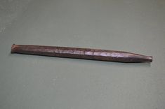 an old wooden object sitting on top of a table