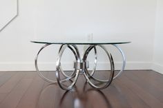 a glass table sitting on top of a hard wood floor