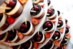 several desserts are arranged on plates with strawberries and chocolate chips in the middle