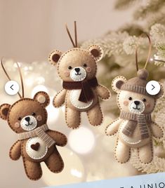 three teddy bears are hanging from a christmas tree ornament with tags on them