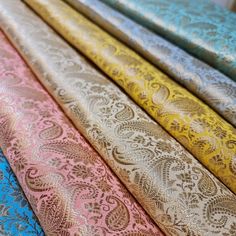 several different colored fabrics are lined up in the same row, with one blue and one pink