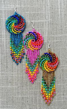 These earrings reflect the cultural traditions of indigenous artisans from Chiapas Mexico. It can take up to an hour to finish every pair. We know you're going to love them as much as we do! They are lightweight and add a pop of color to any outfit. Easy to wear from day to night.  As a special thank you every shipment will receive a FREE GIFT!! Thank you for visiting - Gracias por visitarnos!  Be sure to favorite our shop to get updates on all our new items! Bohemian Dangle Beaded Earrings Fair Trade, Unique Dangle Beaded Earrings For Festivals, Handmade Artisan Beaded Earrings For Festivals, Fair Trade Multicolor Beaded Earrings For Festival, Multicolor Fair Trade Beaded Earrings For Festival, Bohemian Fair Trade Beaded Dangle Earrings, Artisan Fair Trade Beaded Dangle Earrings, Fair Trade Bohemian Beaded Dangle Earrings, Cheap Rainbow Beaded Earrings For Festival