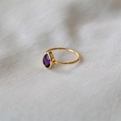 D E T A I L S - Material: 925 Sterling silver Stone: Natural Amethyst Ring The fit: True to US ring size Finish: Smooth and Gold Plated to a high shine S H I P P I N G & P R O D U C T I O N - My current production time is 2-6 business days, which means after those days are up, your order ships! I make everything custom to order, by hand, but I promise you it's worth the wait! R U S H - M Y - O R D E R - If you're in a rush to get your pretty new pieces, please send me a message and I'll let Minimalist Amethyst Gemstone Ring, Dainty Teardrop Gemstone Rings, Purple Teardrop Gemstone Rings, Teardrop Amethyst Ring As Gift, February Birthstone Ring, Purple Amethyst Ring, Textured Ring, Ring Stacking, February Birthstone