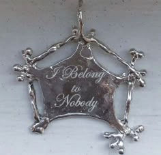 a silver plate that says i belong to nobody