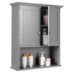 a bathroom cabinet with two doors and three soap dispensers