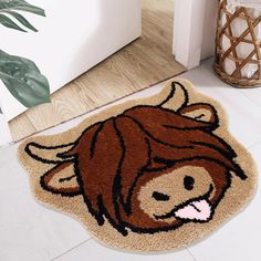 a door mat with an image of a brown cow on the front and side of it