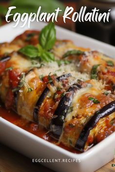 eggplant rollatini with cheese and sauce in a white dish on a wooden table