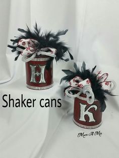 two red and white containers with black feathers on them, one has the letter k