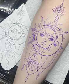 a tattoo on the leg of a woman with a sun and moon behind her head