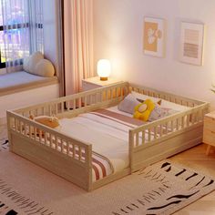 a small child's bed in the corner of a room with a rug on the floor