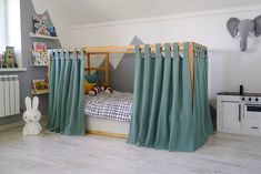 a child's bedroom with green curtains and a bed