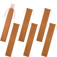 four brown paper bags tied together with string