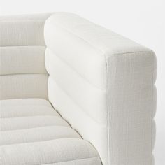 a white couch sitting on top of a wooden floor