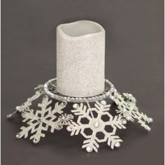 a white candle holder with snowflakes on it