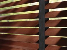 wooden blinds with black slats on them