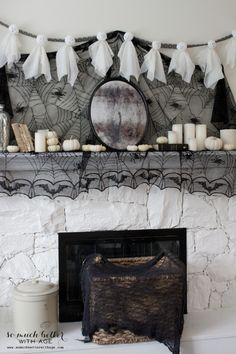 a mantle with candles and decorations on it in front of a white brick fire place