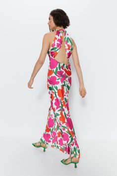 Satin floral print fabric with a lustrous, smooth texture 
 Halterneck silhouette with a keyhole back and crisscross strap detail 
 Fitted, ruched bodice with an asymmetric, flowing A-line skirt 
 Maxi length perfect for evenings out 
This gorgeous floral satin maxi dress from Warehouse is an essential addition to your evening wardrobe. Cut from softly draping satin with a vibrant floral print, it features a slimming ruched bodice and a flowing A-line skirt with an asymmetric hem. The halterneck silhouette flatters the shoulders, while the open back adds a flirty touch with its crisscross strap detail. 
Style this dress with strappy heels and a clutch for cocktails or a night out dancing. The floral print and satin fabrication make it perfect for summer soirées and garden parties. For t Floral Evening Dresses, Satin Evening Dresses, Country Concert Outfit, Skirt Maxi, Floral Print Fabric, Ruched Bodice, Garden Parties, Dresses Floral, Satin Maxi