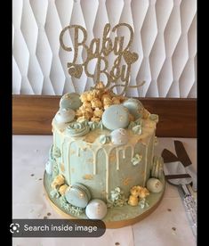 there is a cake that has been decorated with gold and blue decorations on top of it