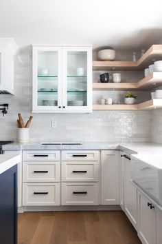 the kitchen is clean and ready for us to use it's white cabinetry