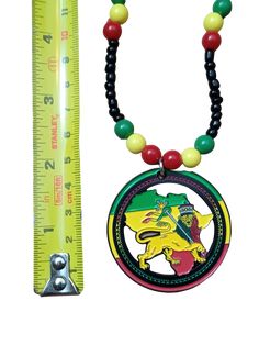 This Lion of Judah Beaded Necklace is a vibrant tribute to Ethiopia and the Rastafarian Movement! The striking combination of red, yellow, and green perfectly honors the official flag of Ethiopia, while the majestic lion adorned with a crown and cross pays homage to Haile Selassie. Wear it with pride and feel the powerful energy of this symbolic piece. Rasta! This necklace features a METAL pendant that is 2" round and solid black on the back side. Measuring 22" in length, it comes with a screw c Adjustable Multicolor Medallion Necklace, Adjustable Multicolor Necklace With Large Pendant, Adjustable Large Pendant Multicolor Necklace, Map Of Africa, Beautiful Lion, Majestic Lion, Haile Selassie, Powerful Energy, Africa Map