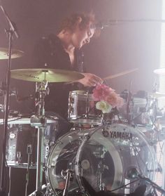 a man is playing drums on stage