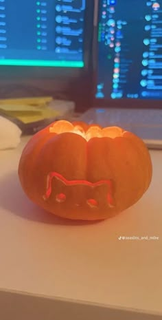 a carved pumpkin sitting on top of a desk