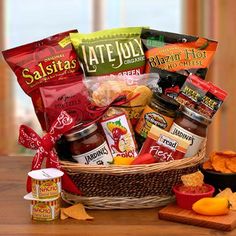 a basket filled with lots of food sitting on top of a wooden table