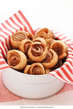 cinnamon roll pretzels in a white bowl on a red and white tablecloth