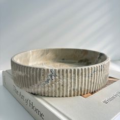 A fluted round bowl made out of concrete would have a distinctive and elegant design. The fluted pattern features a series of vertical grooves or ridges running around the circumference of the bowl, adding texture and a sense of movement to the piece. The concrete material gives the bowl a modern, industrial look, while its round shape provides a timeless and classic feel. Measurements:  Bowl Diameter: 8 3/4"  Tall: 2" Each concrete item is handmade from scratch, as concrete is made from natural Large Coffee Table Bowl, Concrete Fruit Bowl, Coffee Table Bowl, Concrete Material, Catchall Bowl, Bowl Centerpiece, Clay Candle, Concrete Bowl, Concrete Materials