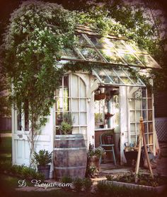 an old greenhouse is surrounded by greenery and potted plants