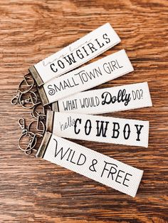 four key chains with words on them sitting on a table