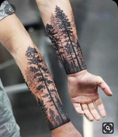 two people holding hands with trees on them