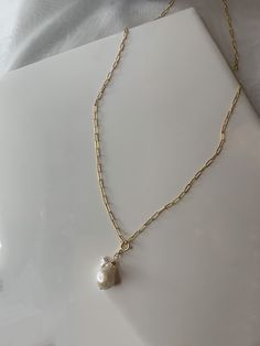 small baroque pearl drop suspended from delicate 14k gold filled paper clip chain necklace. Show it up with plunge neckline! closure: spring clasp 14k gold filled is both durable and suited for everyday use. Gold filled is not to be confused with gold plating as filled literally has 100% more gold than gold plating. Gold filled is much more valuable and tarnish resistant. Please allow for slight variations due to the unique nature of the materials used. Gold Necklace With Baroque Pearl And Paperclip Chain, Teardrop Pearl Charm Necklace In 14k Gold Filled, 14k Gold-filled Teardrop Necklace With Pearl Charm, 14k Gold Filled Teardrop Necklace With Pearl Charm, Gold Pearl Necklace With Paperclip Chain, Minimalist Gold Pearl Necklace With Paperclip Chain, Everyday Gold Baroque Pearl Necklace, Elegant Jewelry With Baroque Pearl And Paperclip Chain, Everyday Gold Necklace With Baroque Pearls