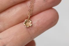 Solid 14k gold cherry blossom charm necklace. A delicate and beautifully detailed charm. Cherry blossoms are a symbolic flower of spring, a time of renewal, and the fleeting nature of life. In Japanese culture the cherry blossom represents the fragility and the beauty of life. Available with a solid gold chain, gold filled chain or as a charm only. Charm comes with a 4mm jump ring, if you would like to add clasp to add to your charm bracelet here is the link. https://www.etsy.com/listing/1021468 Dainty Flower Necklace, Chinese Cherry Blossom, Japanese Necklace, Cherry Blossom Jewelry, Cherry Blossom Necklace, Solid Gold Charms, Solid Gold Chains, Fancy Jewellery, Floral Necklace