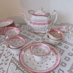 a table topped with pink and white dishes