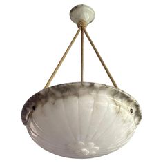 a white bowl hanging from a ceiling fixture