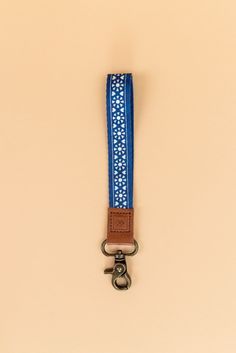 A wrist lanyard is great for keeping your keys, thread essentials, and anything else you need nice and organized. With a fun touch of color, the Sawyer is our new fave. polyester strap, genuine leather loop, and metal clasp quality hardware clasp length: 5.5 in (15 cm) width: ¾ in (2 cm) Wrist Lanyard For Keys, Athleisure Mom, Thread Wallets, Clogs Heels, Invert Colors, Mom Accessories, Hidden Images, Wrist Lanyard, Capri Blue