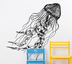 a black and white jellyfish wall decal next to a yellow chair in a children's room