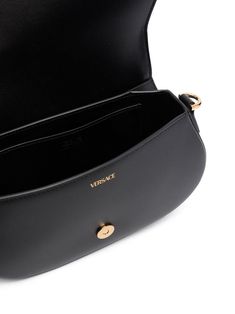 Expertly crafted with gold-tone metal hardware, the Greca Goddess Shoulder Bag features a magnetic fastening flap for ease of access. Its versatile design includes a removable leather strap and chain shoulder strap with a leather shoulder pad, as well as an internal flat pocket for added organization. The luxurious leather lining adds a touch of sophistication to any outfit. Width: 24 cm Height: 15 cm Depth: 4.5 cm Leather strap: 120 cm Chain strap: 120 cm | Versace Women's Greca Goddess Shoulde Luxury Shoulder Bag With Metal Logo For Everyday Use, Luxury Everyday Shoulder Bag With Metal Logo, Luxury Modern Shoulder Bag With Logo Plaque, Luxury Black Leather Chest Bag, Luxury Black Shoulder Bag With Engraved Logo, Luxury Women's Shoulder Bag With Logo Plaque, Luxury Shoulder Chest Bag With Removable Pouch, Luxury Black Chest Bag With Removable Pouch, Luxury Women's Shoulder Bag With Designer Logo